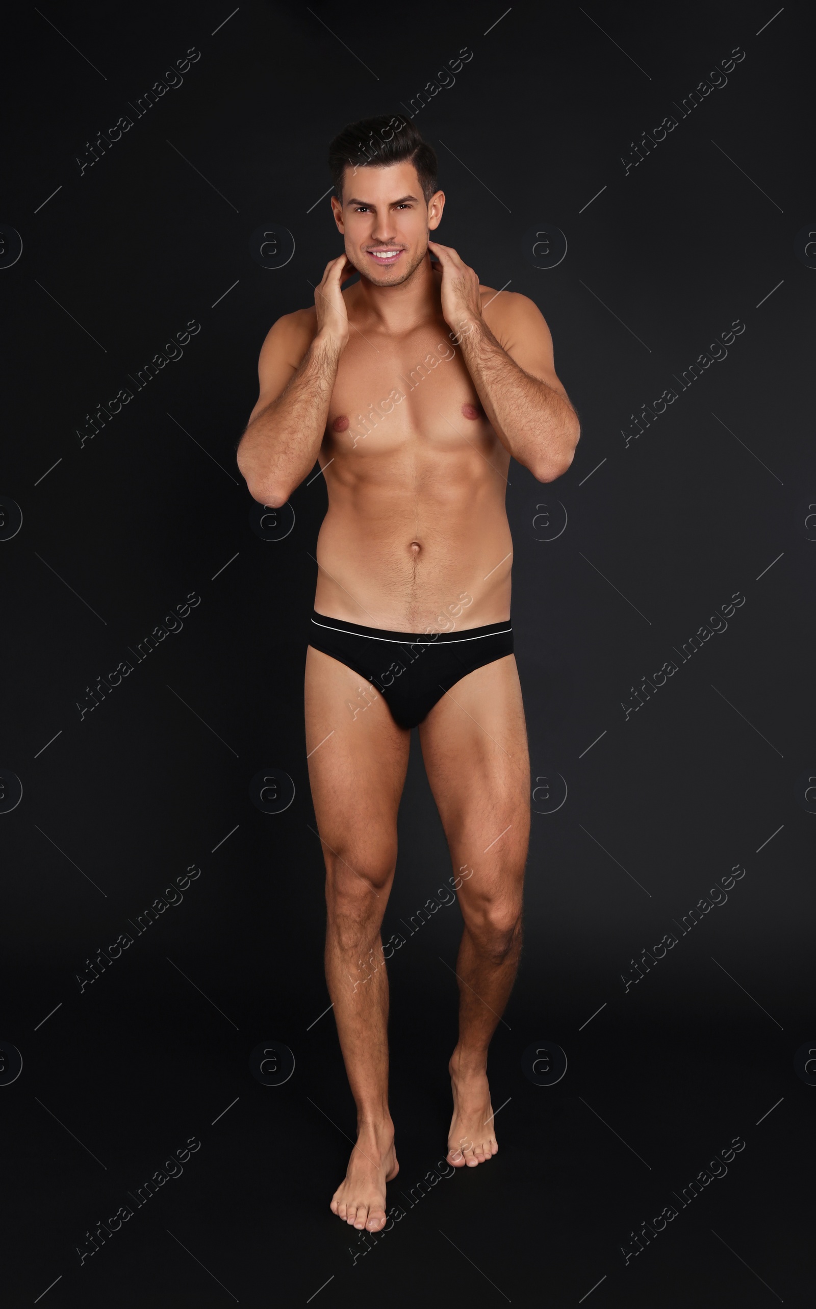 Photo of Handsome man in underwear on black background