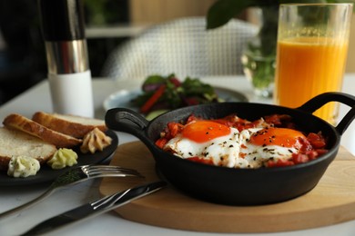 Tasty Shakshouka served on white table. Traditional Arabic dish