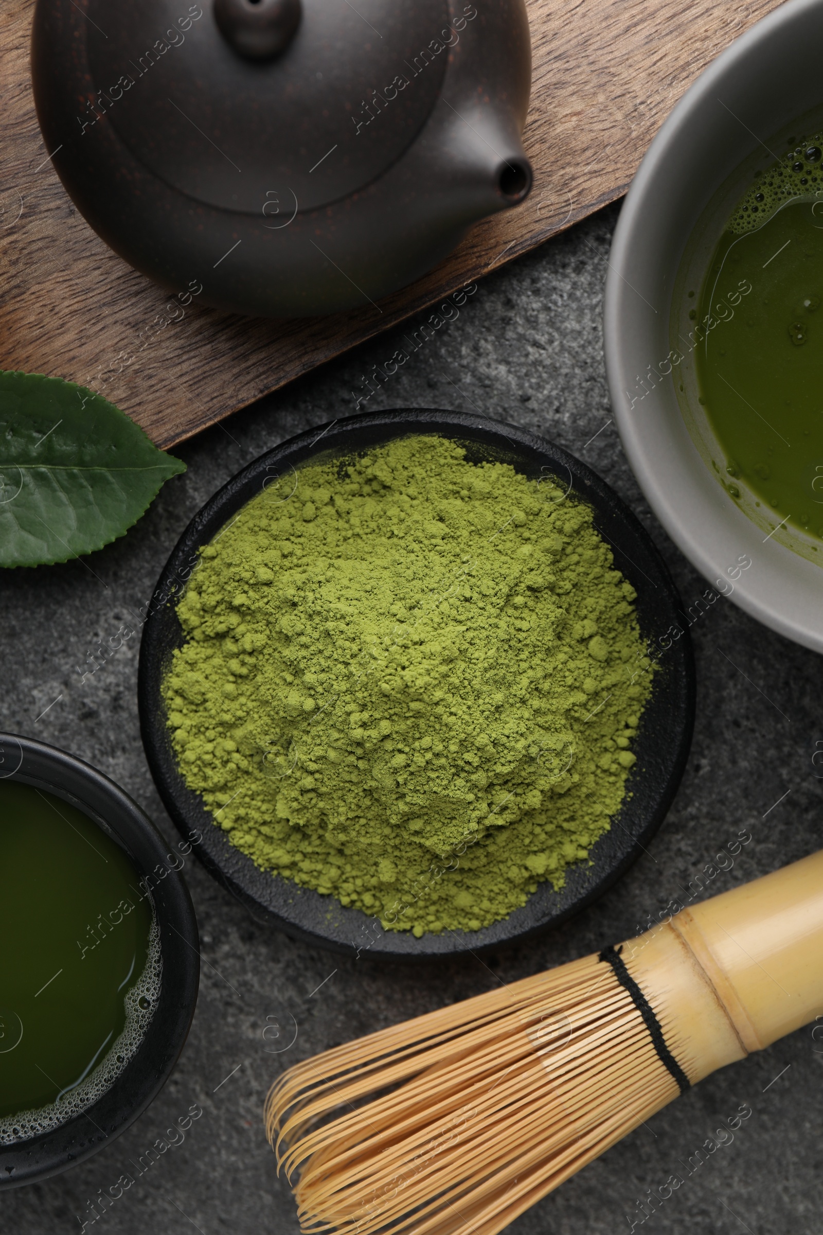 Photo of Flat lay composition with green matcha powder on grey table