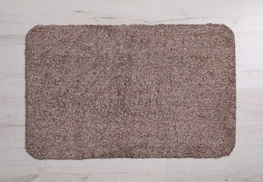 Photo of New clean door mat on floor, top view