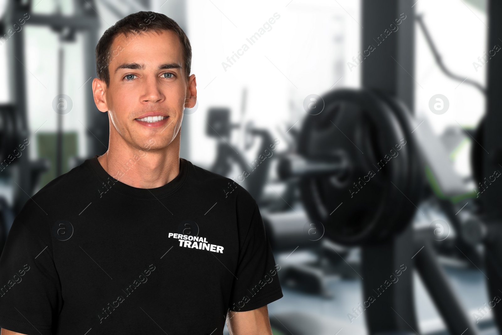 Image of Portrait of professional personal trainer in gym. Space for text