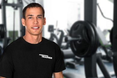 Image of Portraitprofessional personal trainer in gym. Space for text