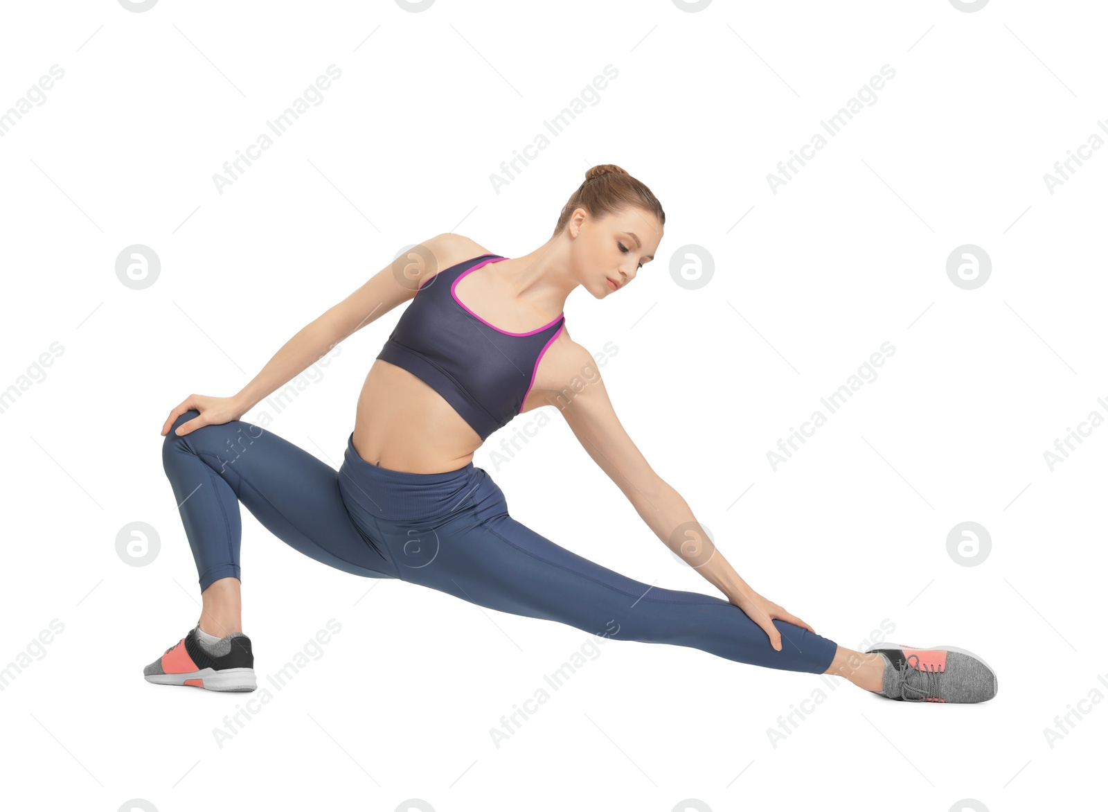 Photo of Yoga workout. Young woman stretching on white background