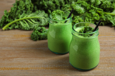 Photo of Tasty fresh kale smoothie on wooden table