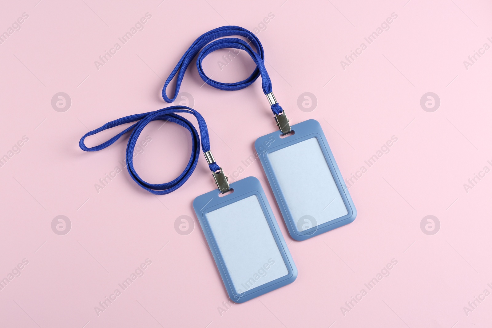 Photo of Blank badges on pink background, flat lay. Mockup for design