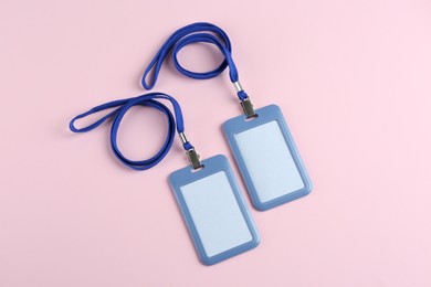 Photo of Blank badges on pink background, flat lay. Mockup for design