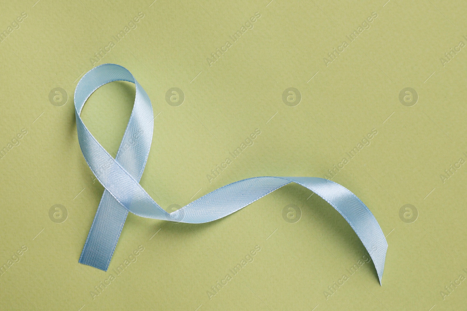 Photo of International Psoriasis Day. Ribbon as symbol of support on green background, top view. Space for text