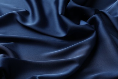 Texture of blue crumpled silk fabric as background, closeup