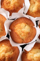 Delicious sweet muffins as background, top view