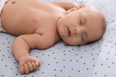 Photo of Cute little baby sleeping on bed, closeup