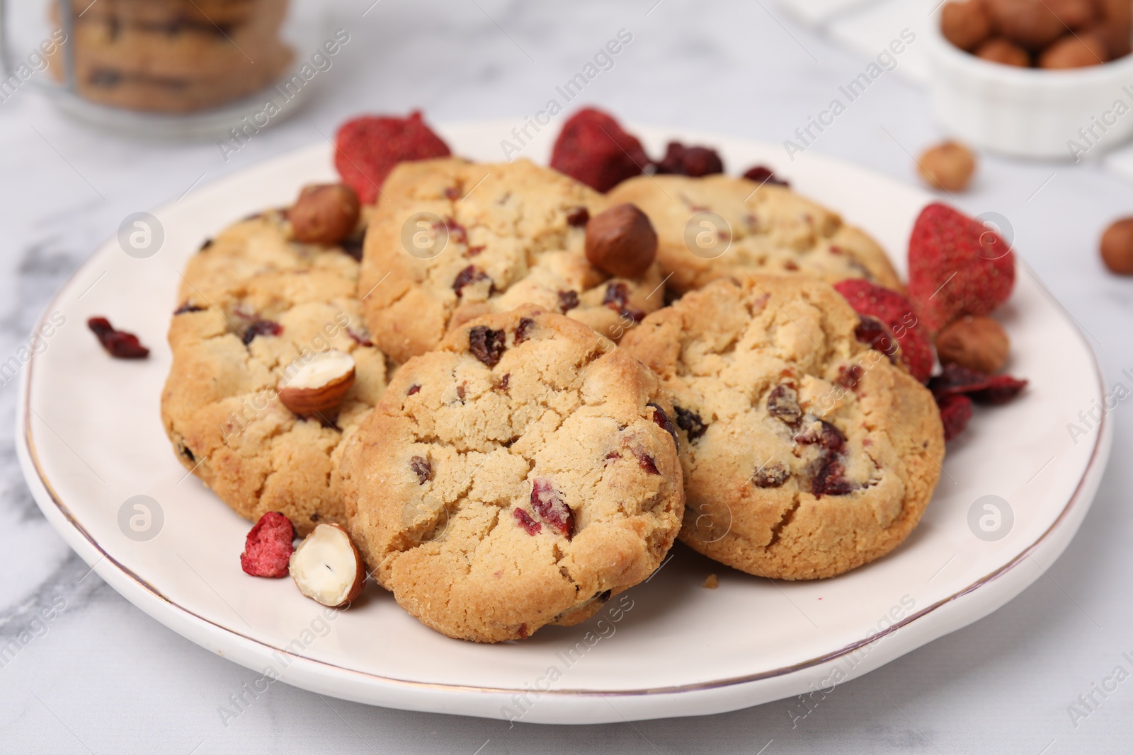 Cookies with freeze dried fruits and nuts on white marble table, closeup Photo of Cookies with freeze dried fruits and nuts on white marble table, closeup