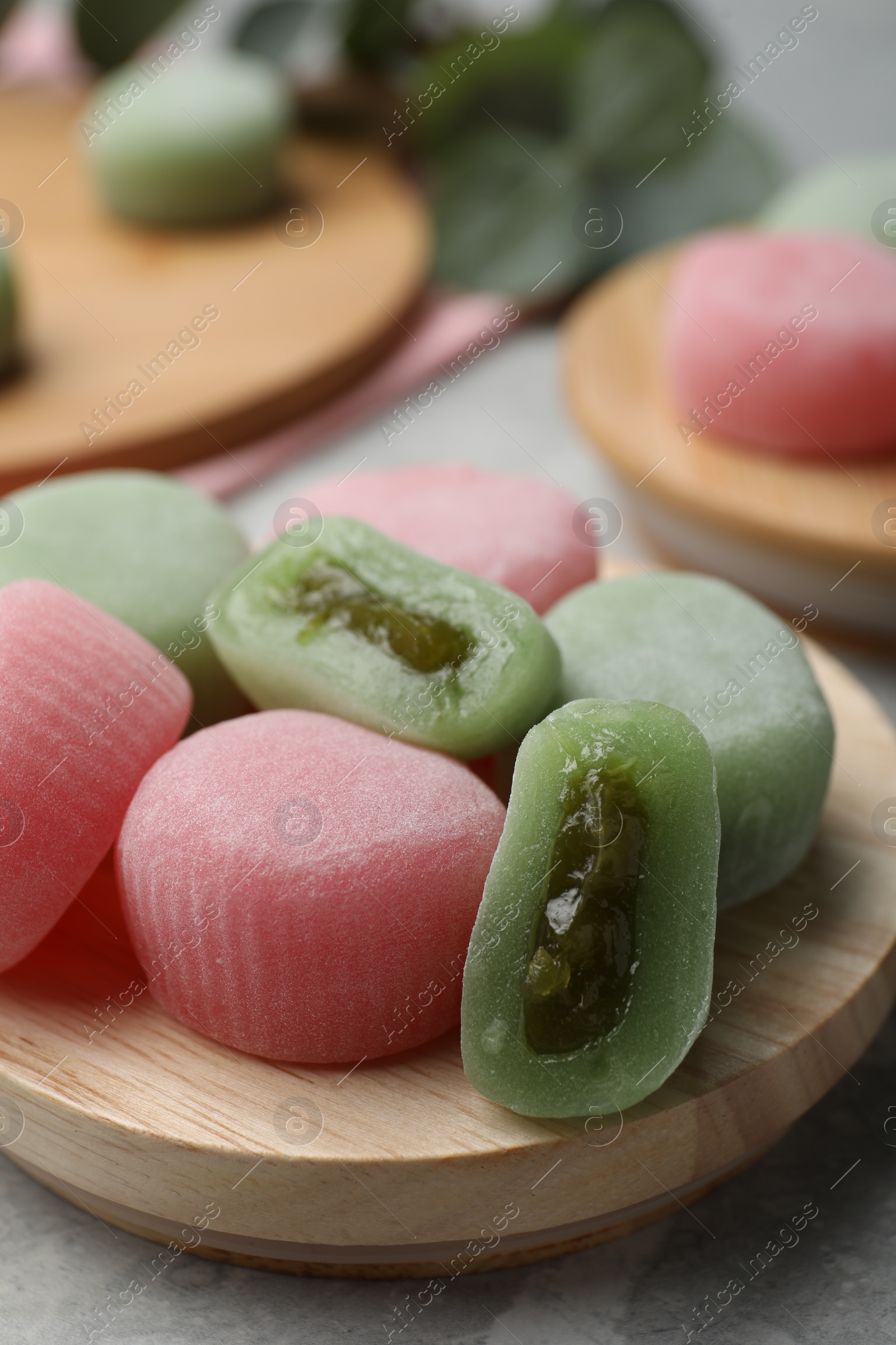 Photo of Many different delicious mochi on wooden board, closeup. Traditional Japanese dessert