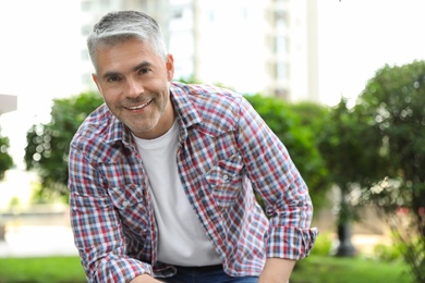 Portrait of handsome mature man in park