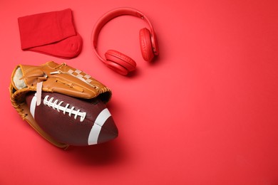 Photo of Sports equipment. Baseball glove, ball, socks and headphones on red background, flat lay. Space for text
