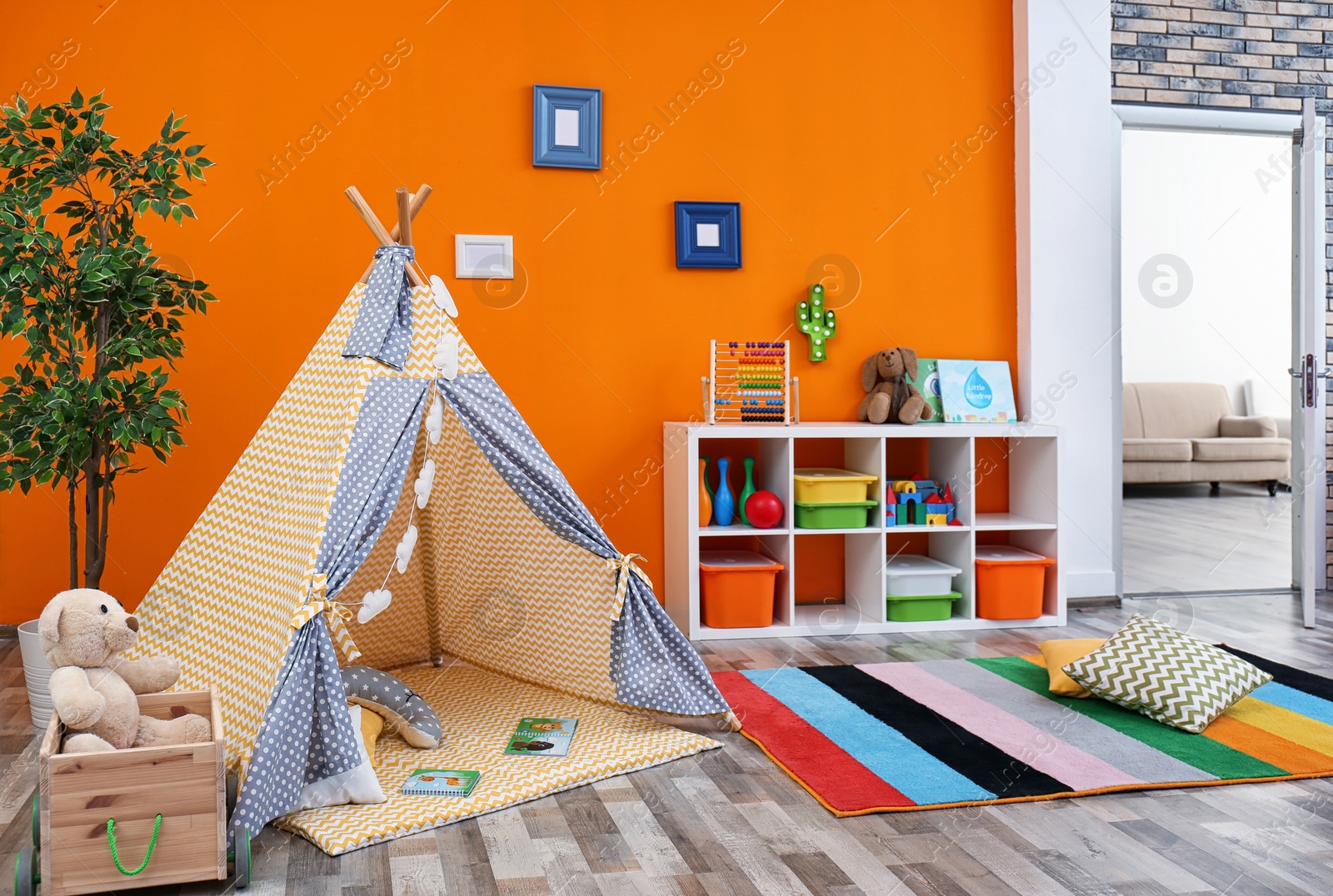 Photo of Cozy kids room interior with play tent and toys