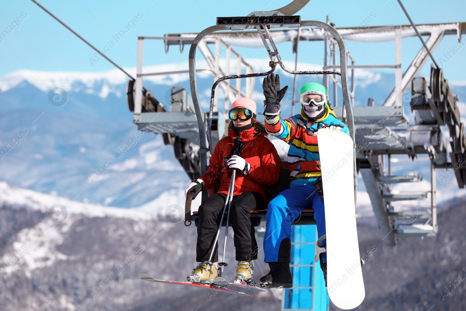 Photo of People using chairlift at mountain ski resort. Winter vacation