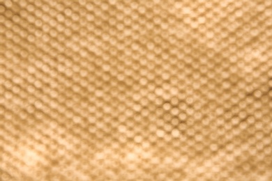 Photo of Blurred view of golden surface as background