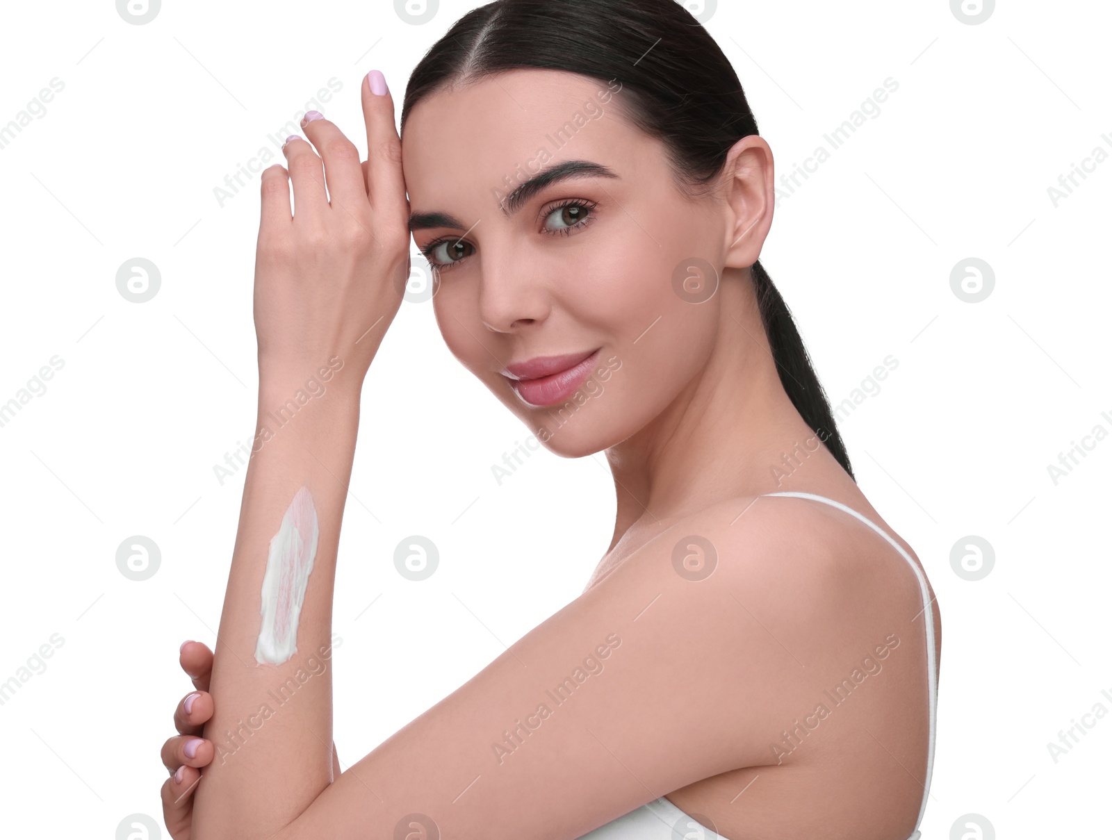 Photo of Beautiful woman with smear of body cream on her arm against white background