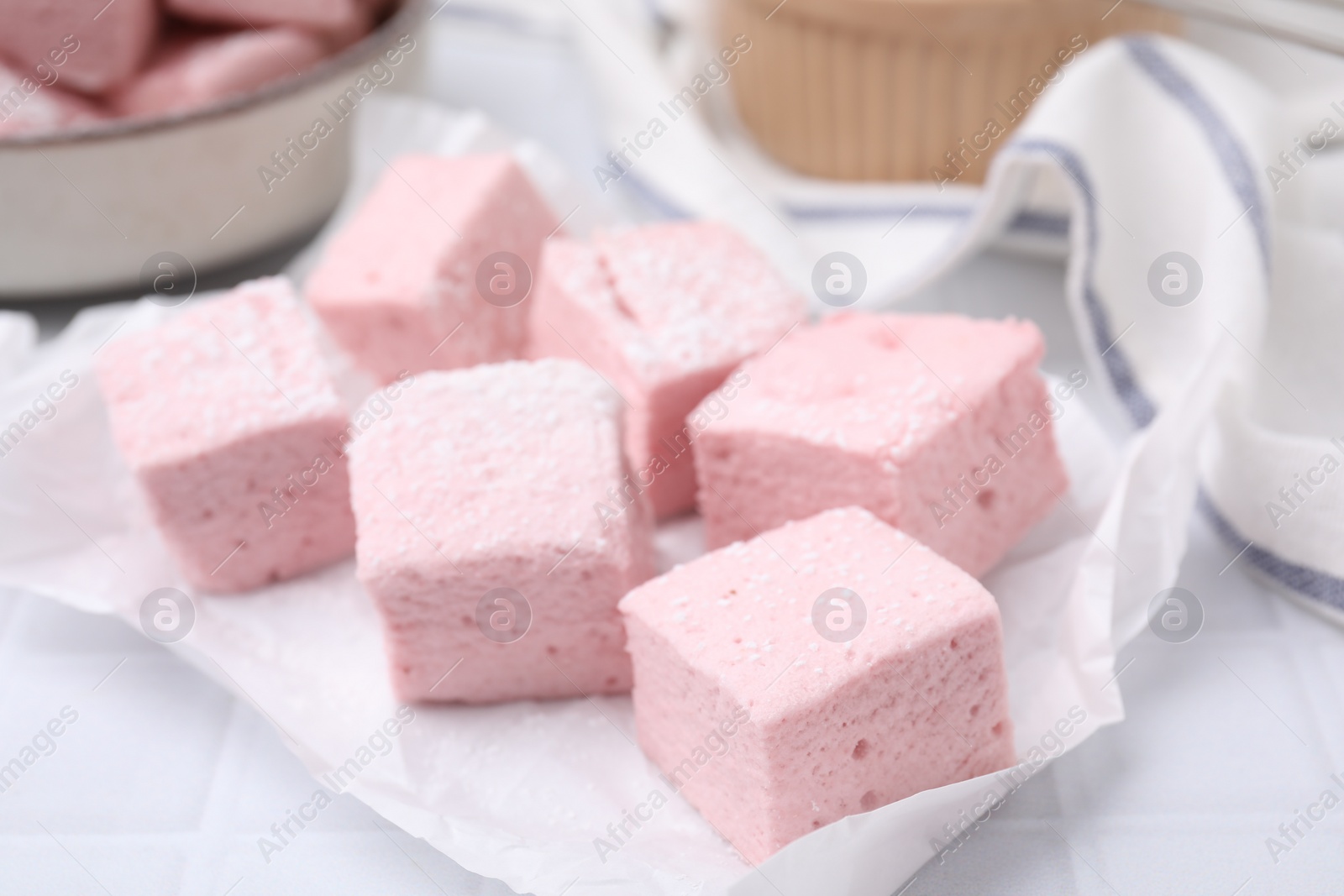 Photo of Delicious sweet marshmallows on white table, closeup