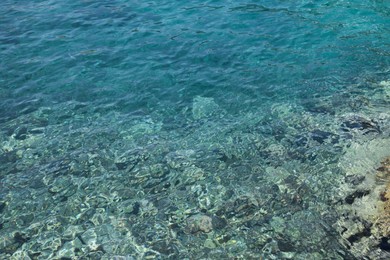 Photo of Shallow water with rocky sea bottom as background
