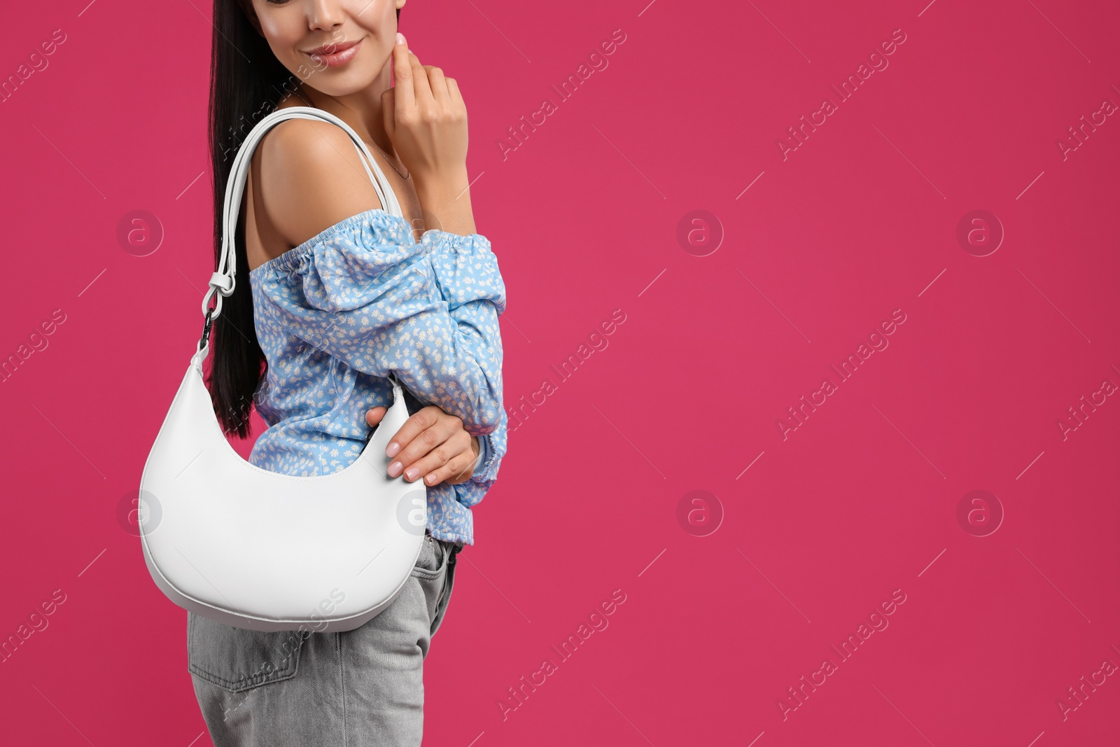 Photo of Fashionable young woman with stylish bag on pink background, closeup. Space for text