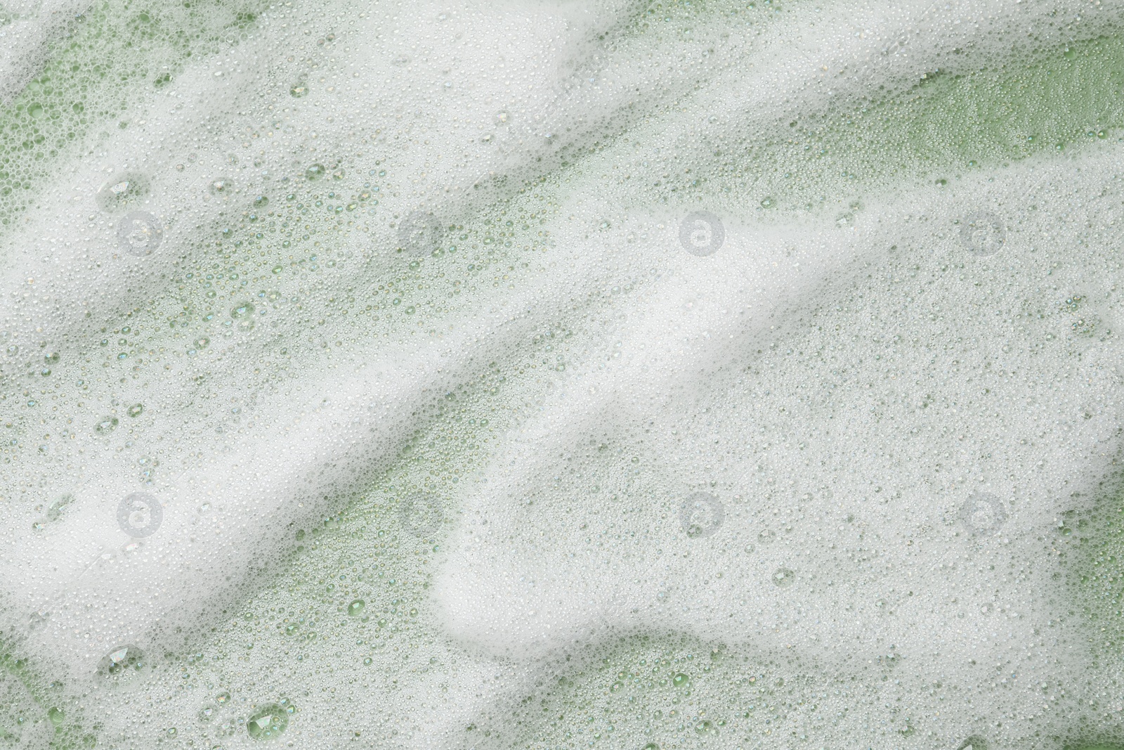 Photo of White washing foam on olive background, top view