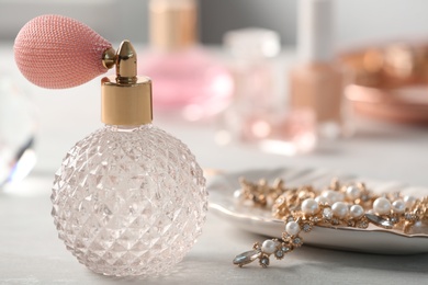 Perfume bottle and jewellery on dressing table