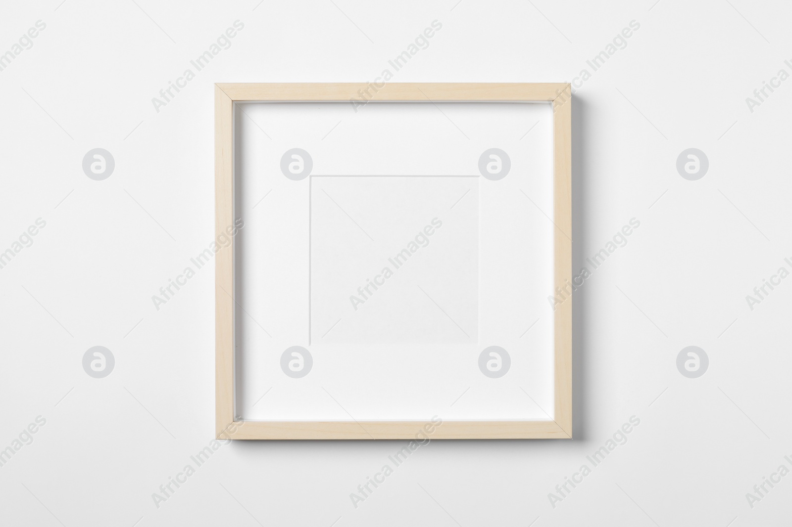 Photo of Empty wooden frame on white background. Mockup for design