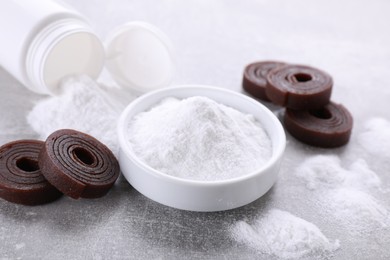 Photo of Sweet fructose powder and fruit leather rolls on light grey table