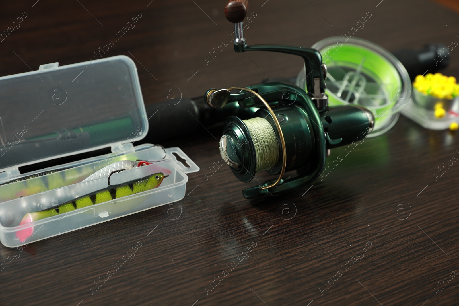 Photo of Fishing tackle on dark wooden background, closeup