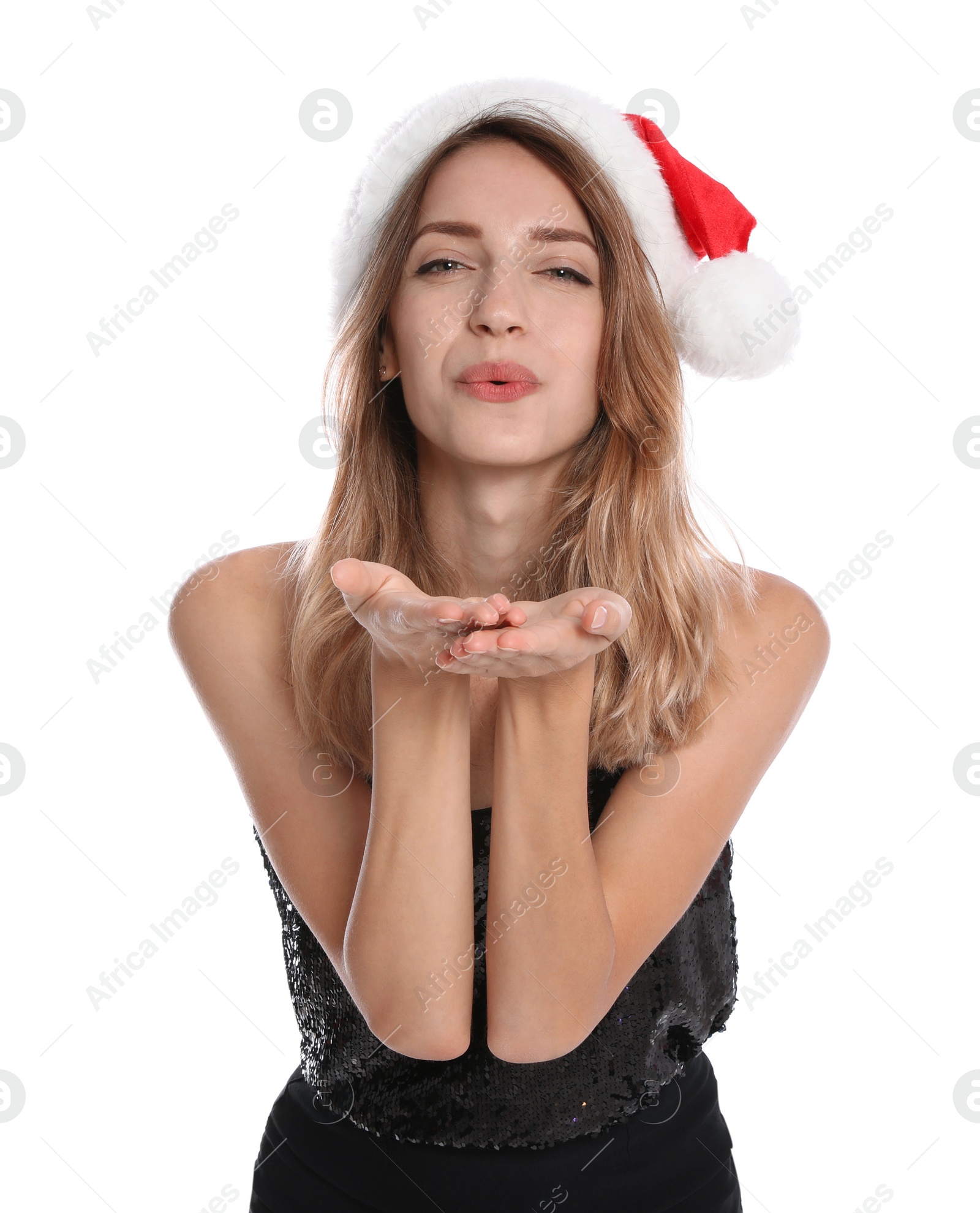 Photo of Happy young woman in Santa hat on white background. Christmas celebration