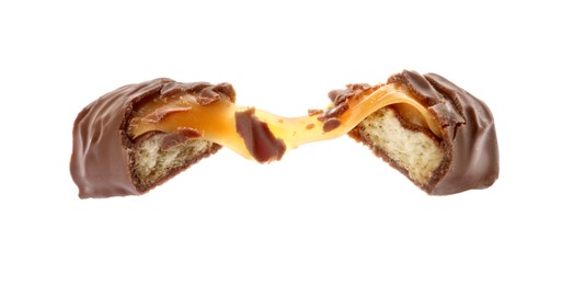 Photo of Pieces of chocolate bar with caramel on white background