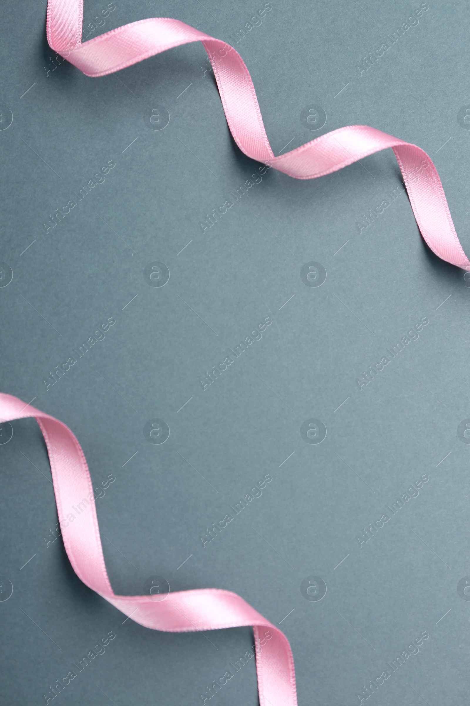 Photo of Beautiful pink ribbons on grey background, flat lay. Space for text