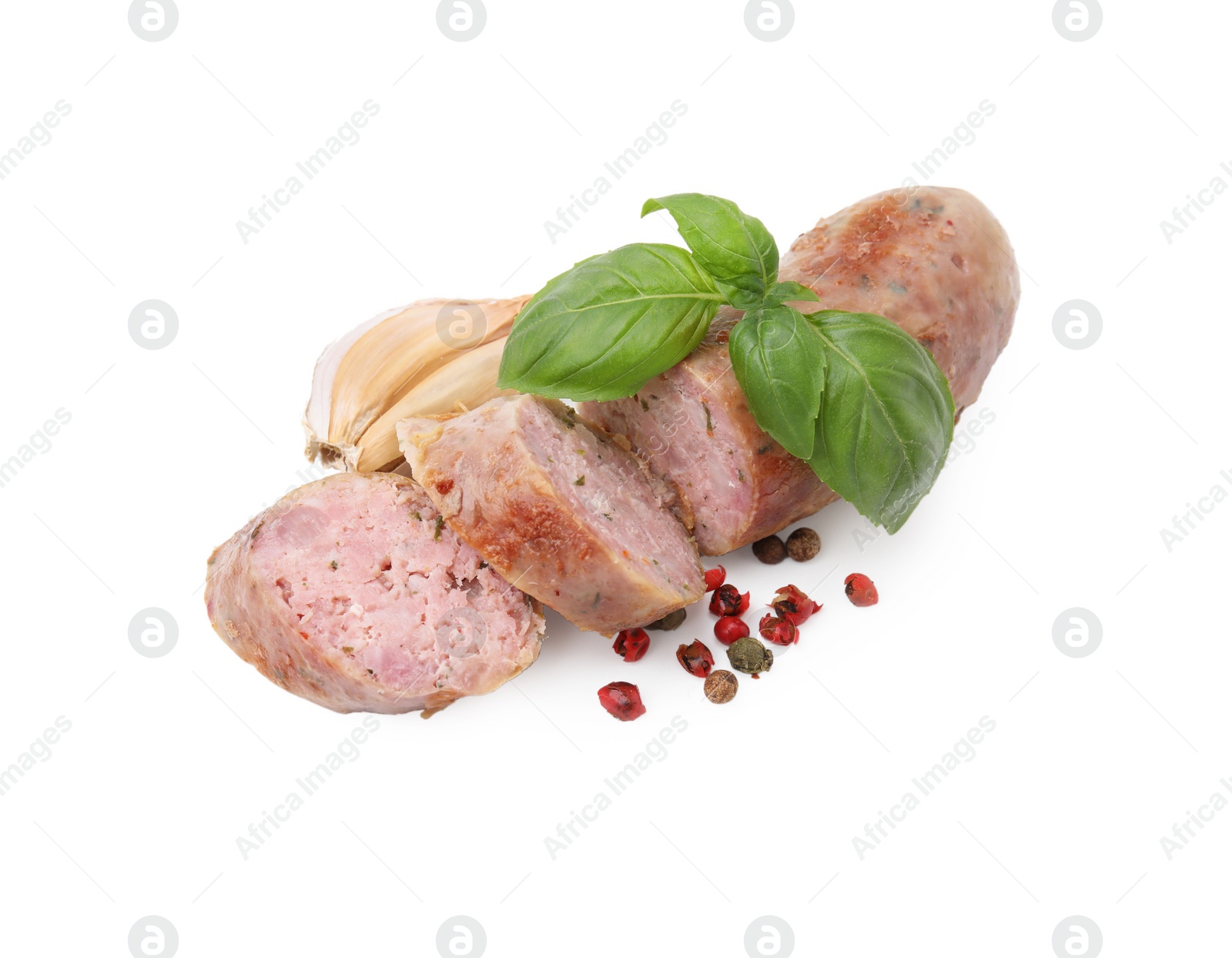 Photo of Tasty cut homemade sausage, garlic, peppercorns and basil leaves isolated on white