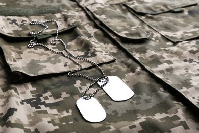 Photo of Military ID tags with chain on camouflage uniform