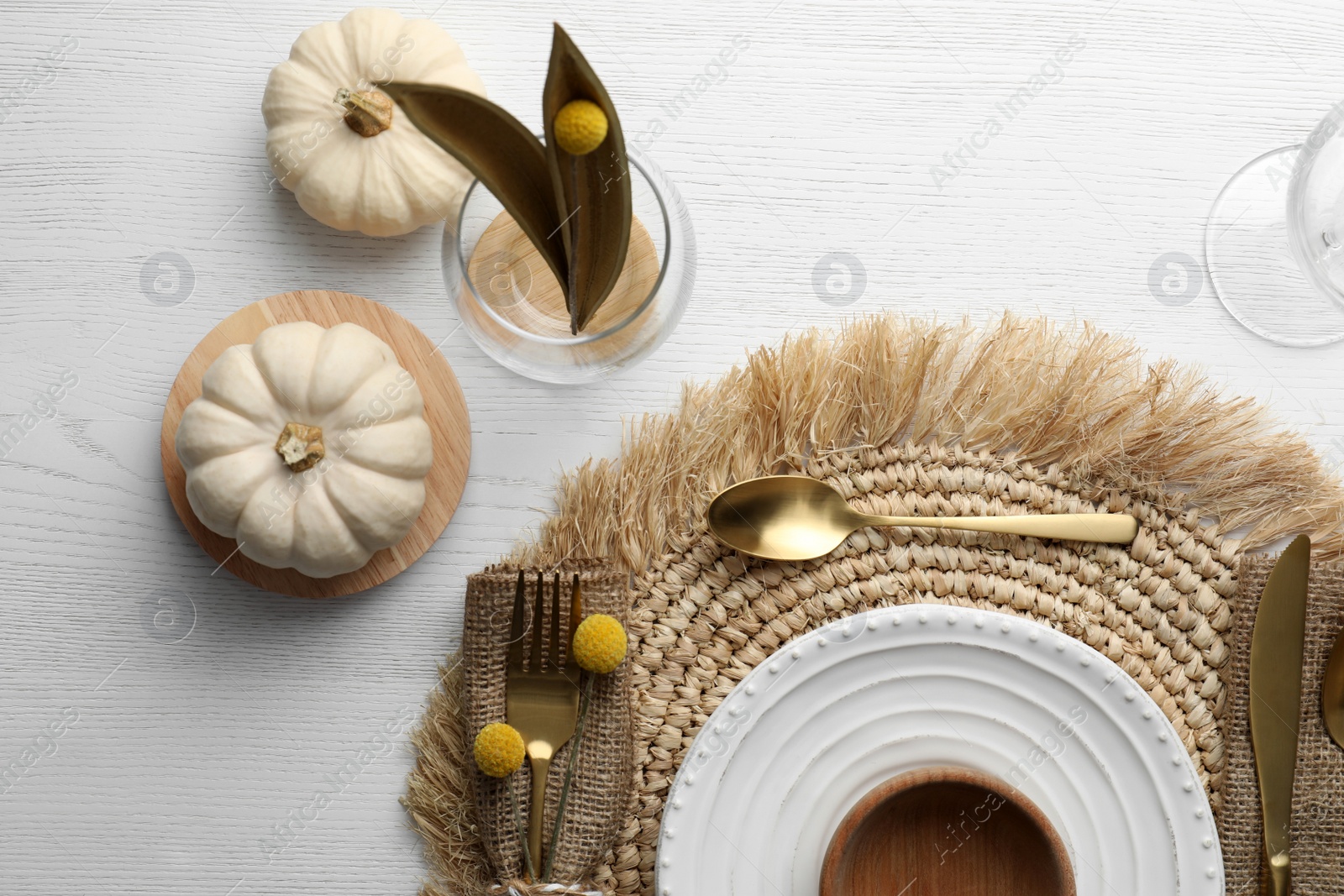 Photo of Autumn table setting with pumpkins on white wooden background, flat lay