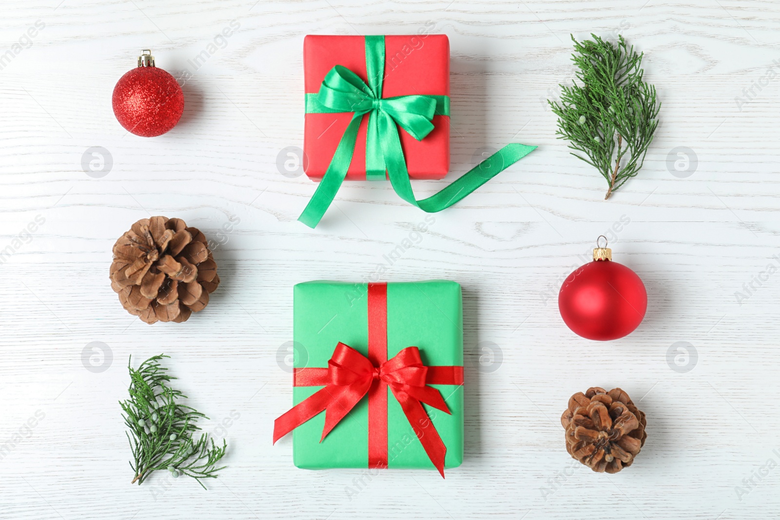 Photo of Flat lay composition with Christmas gift boxes on white wooden background