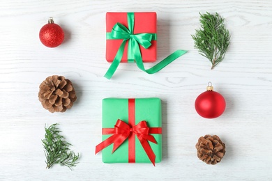 Flat lay composition with Christmas gift boxes on white wooden background