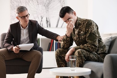 Professional psychotherapist working with military man in office