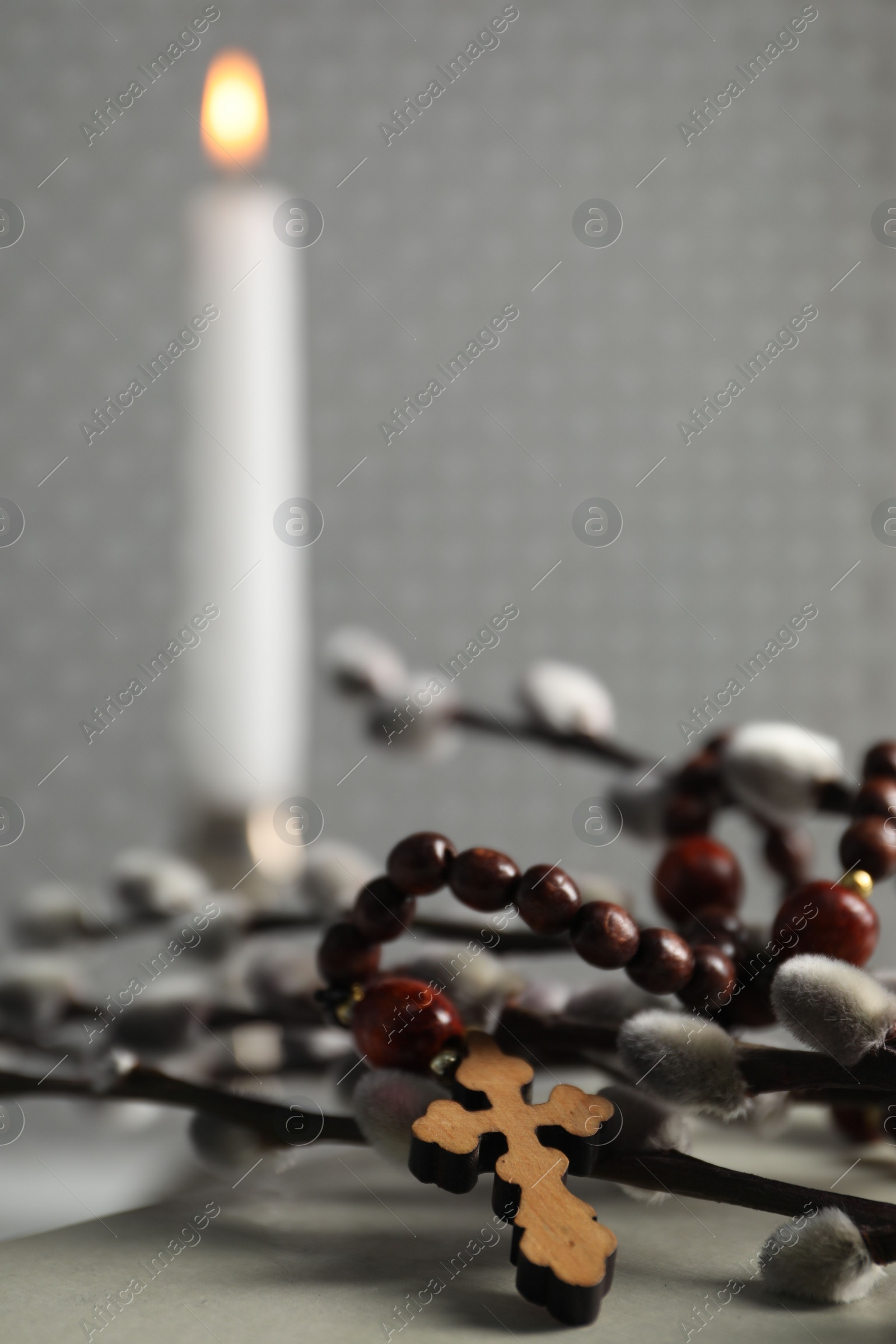 Photo of Rosary beads and willow branches on table, closeup