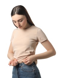 Photo of Diabetes. Woman making insulin injection into her belly on white background