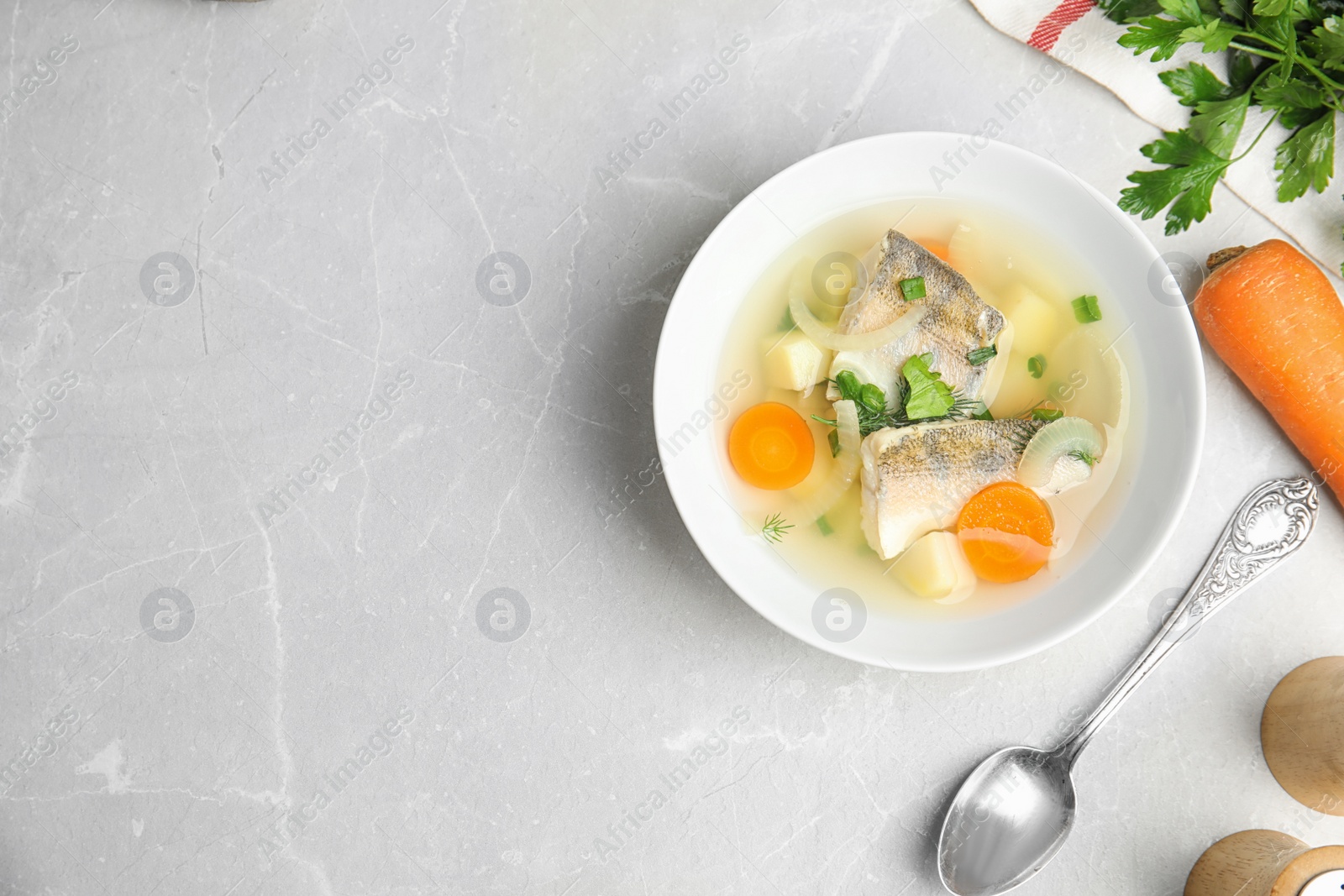 Photo of Delicious fish soup served on light table, flat lay. Space for text