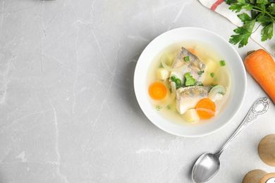 Photo of Delicious fish soup served on light table, flat lay. Space for text