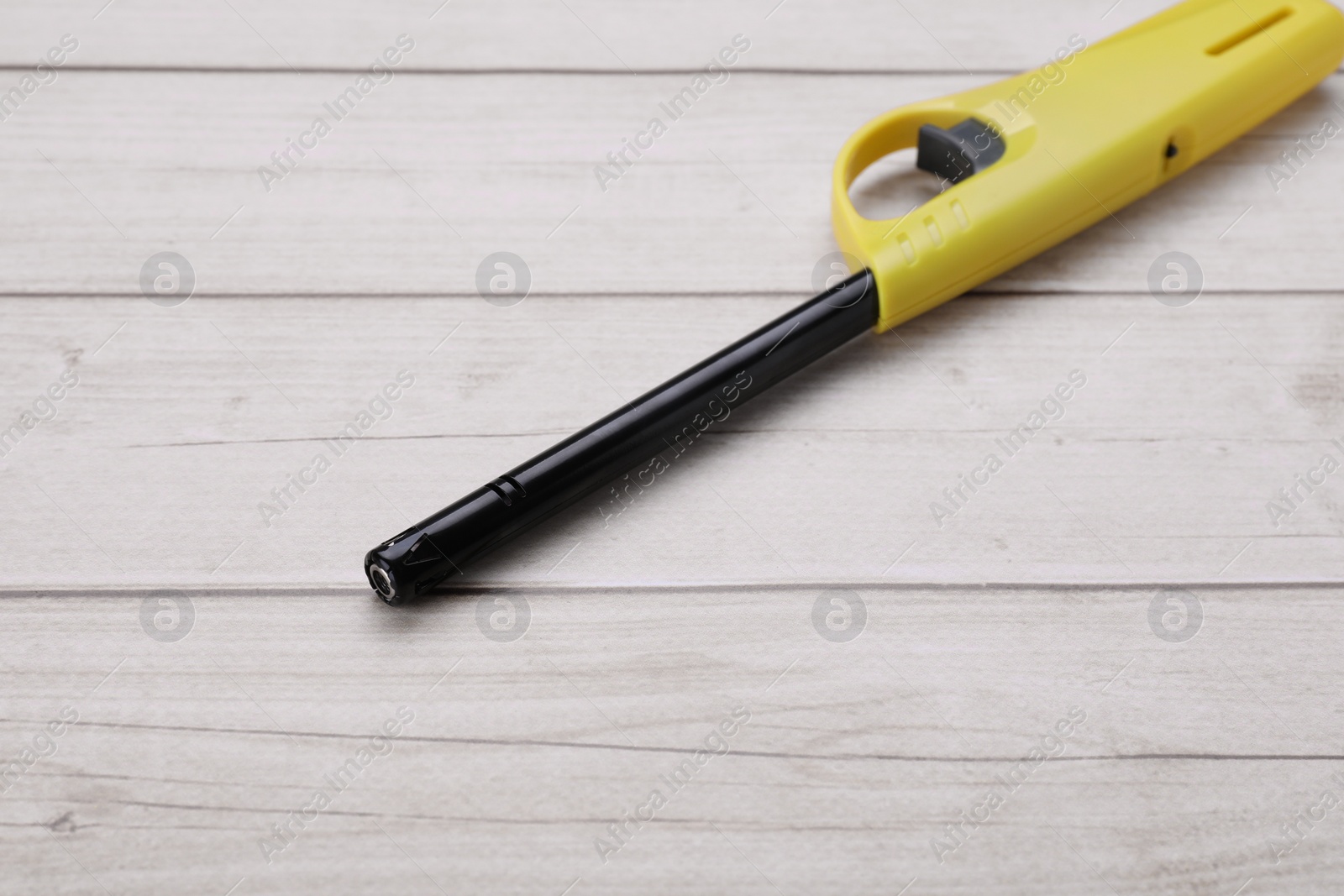 Photo of One gas lighter on white wooden table