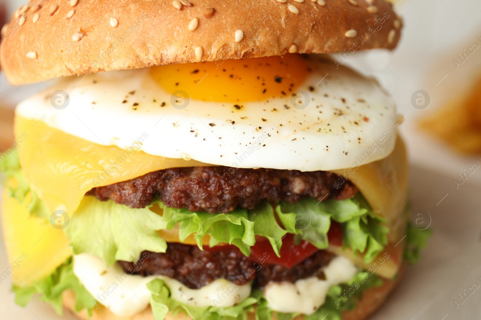 Photo of Closeup view of tasty burger with fried egg