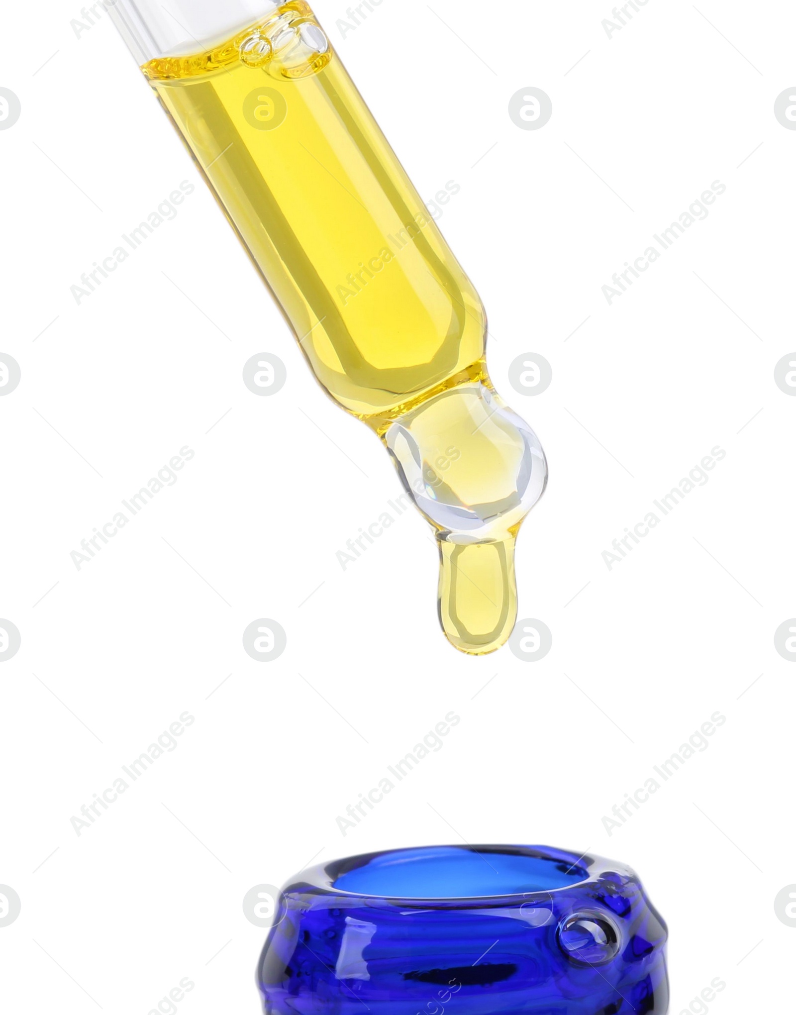 Photo of Dripping tincture from pipette into bottle isolated on white