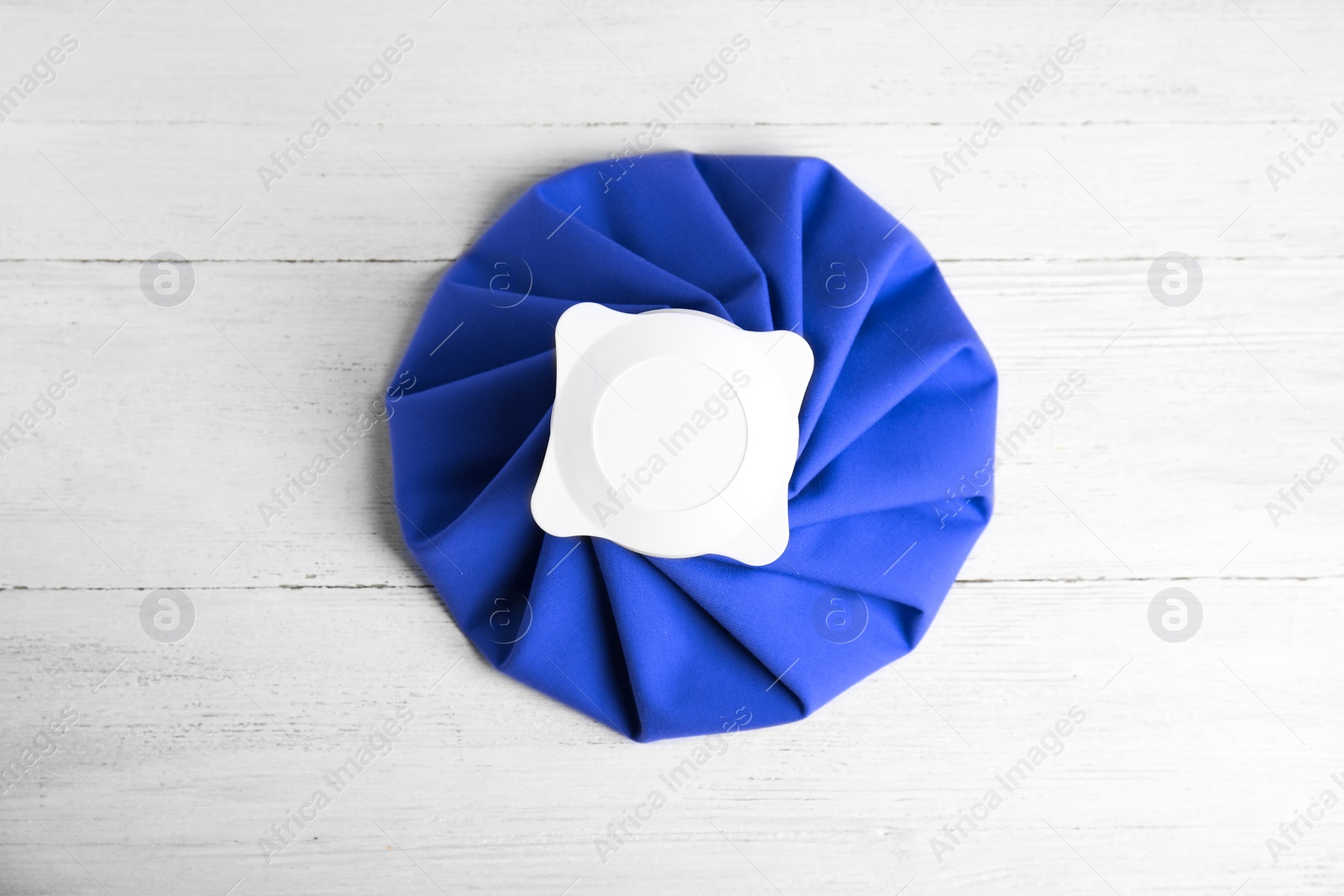 Photo of Ice pack on white wooden table, top view