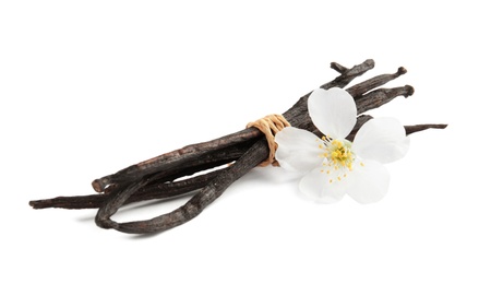 Aromatic vanilla sticks and flower on white background