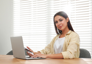 Young woman working with laptop in office