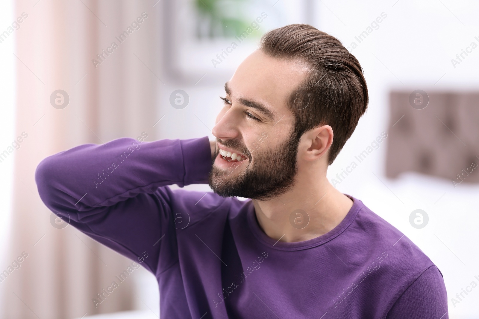 Photo of Portrait of young man with beautiful hair indoors